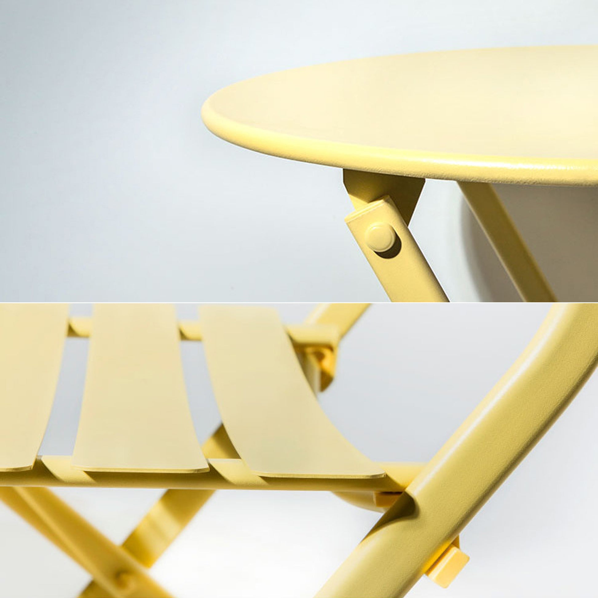 Closeup of a pale yellow metal folding table showcasing its smooth surface and support structure