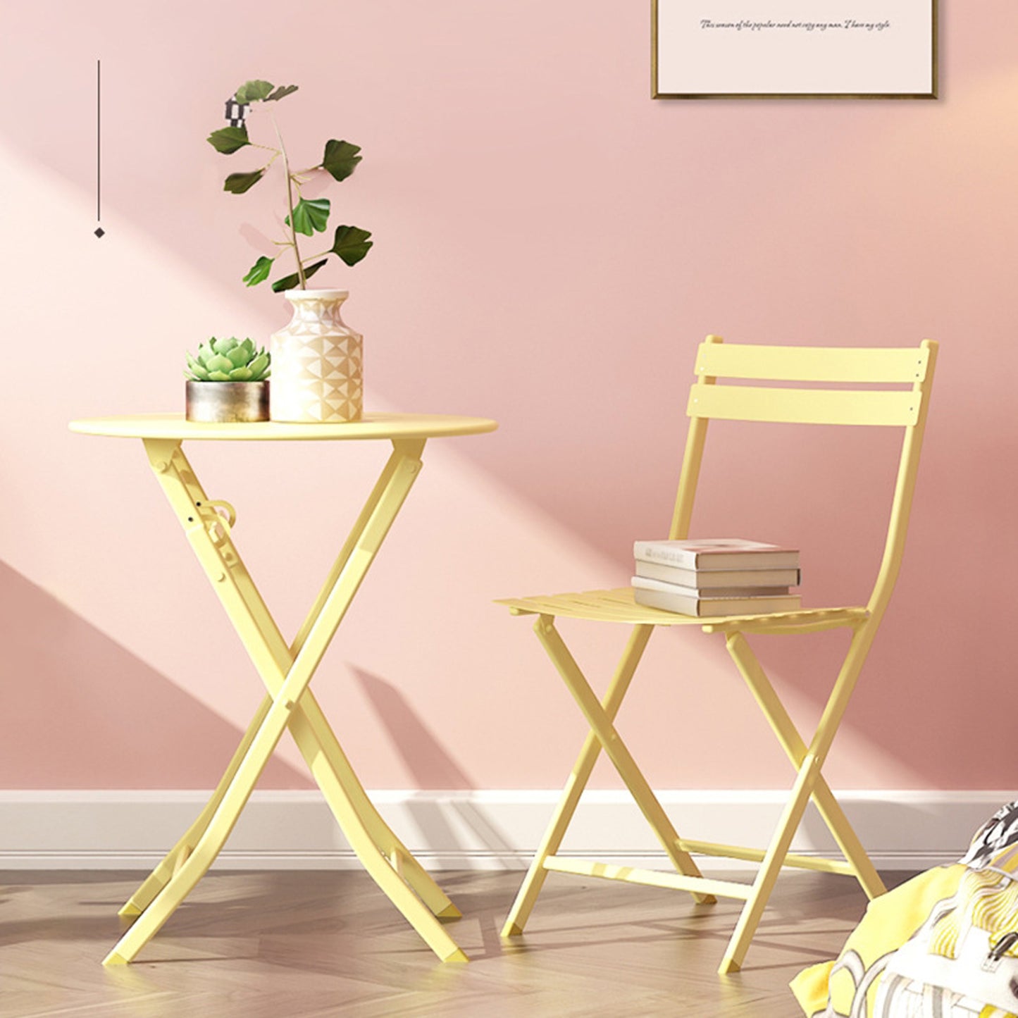 Compact yellow metal bistro chair with a stack of books perfect for outdoor seating