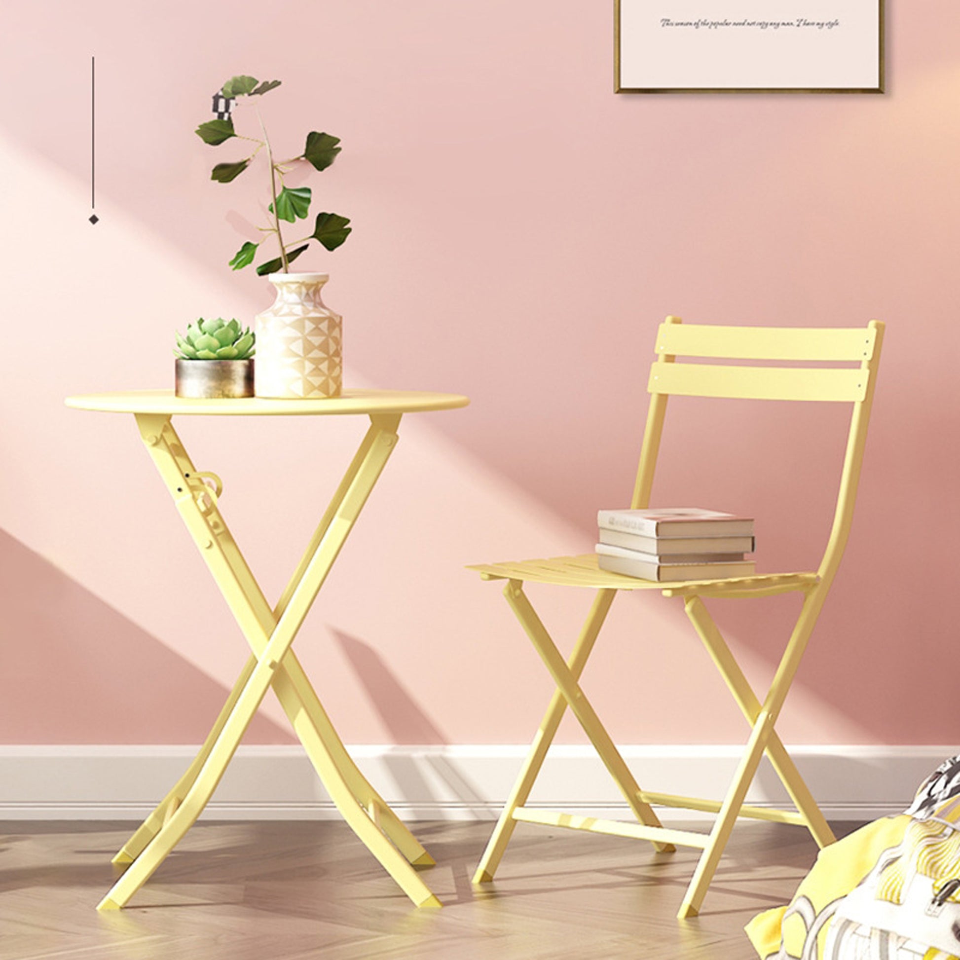 Compact yellow metal bistro chair with a stack of books perfect for outdoor seating