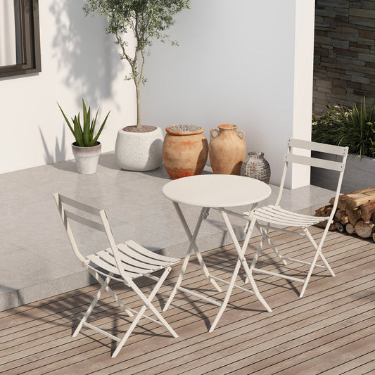 White metal folding bistro set with round table and two chairs on a wooden deck