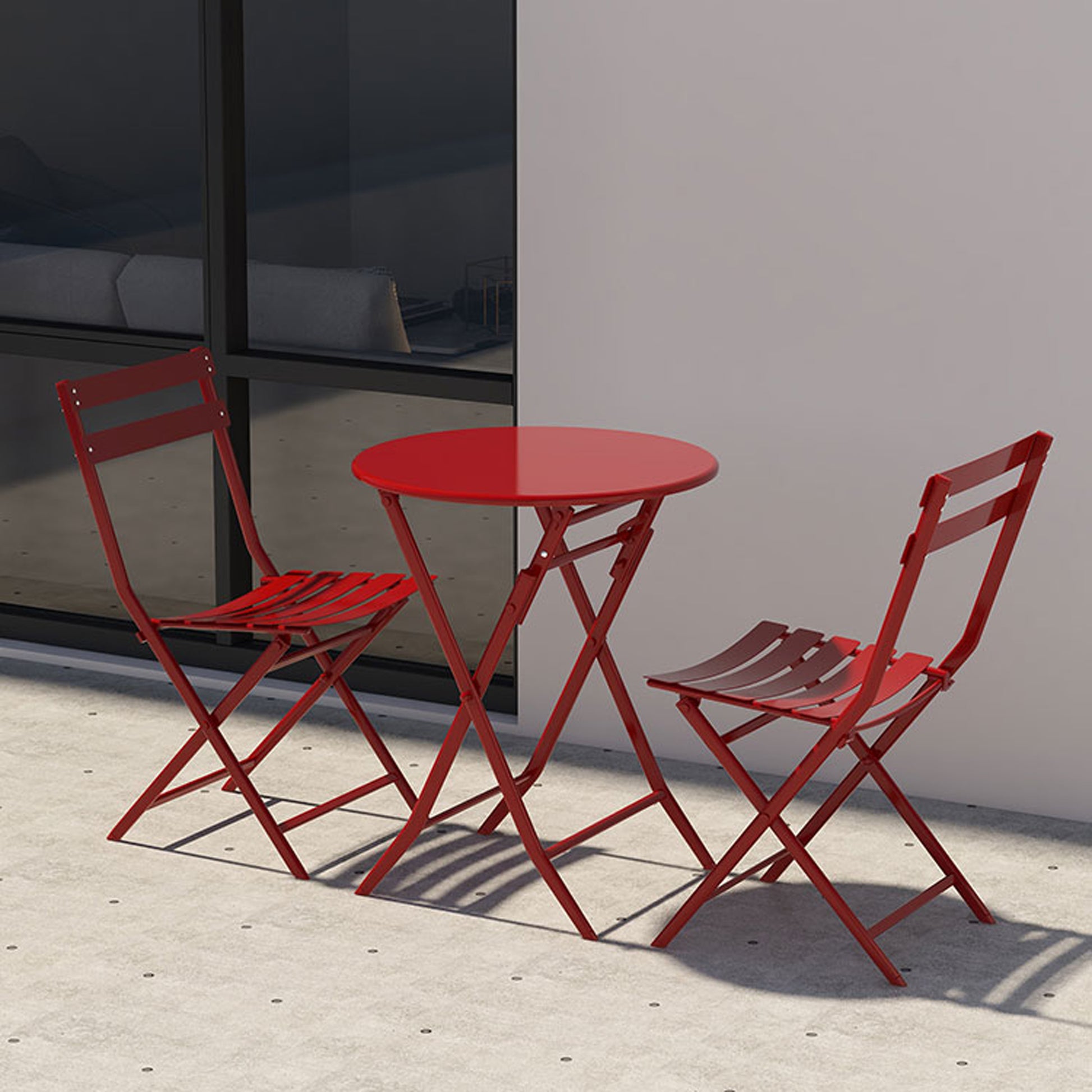 Red metal bistro set with two folding chairs and a round table perfect for outdoor seating