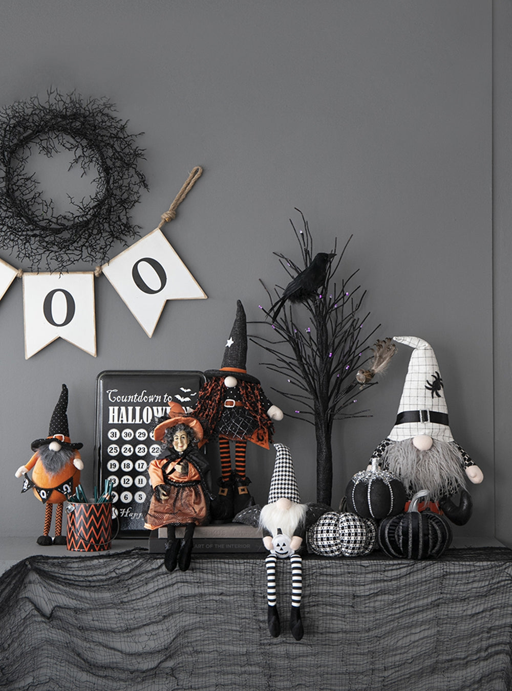 Group of Halloween gnomes and decorations including a witch gnome and pumpkins