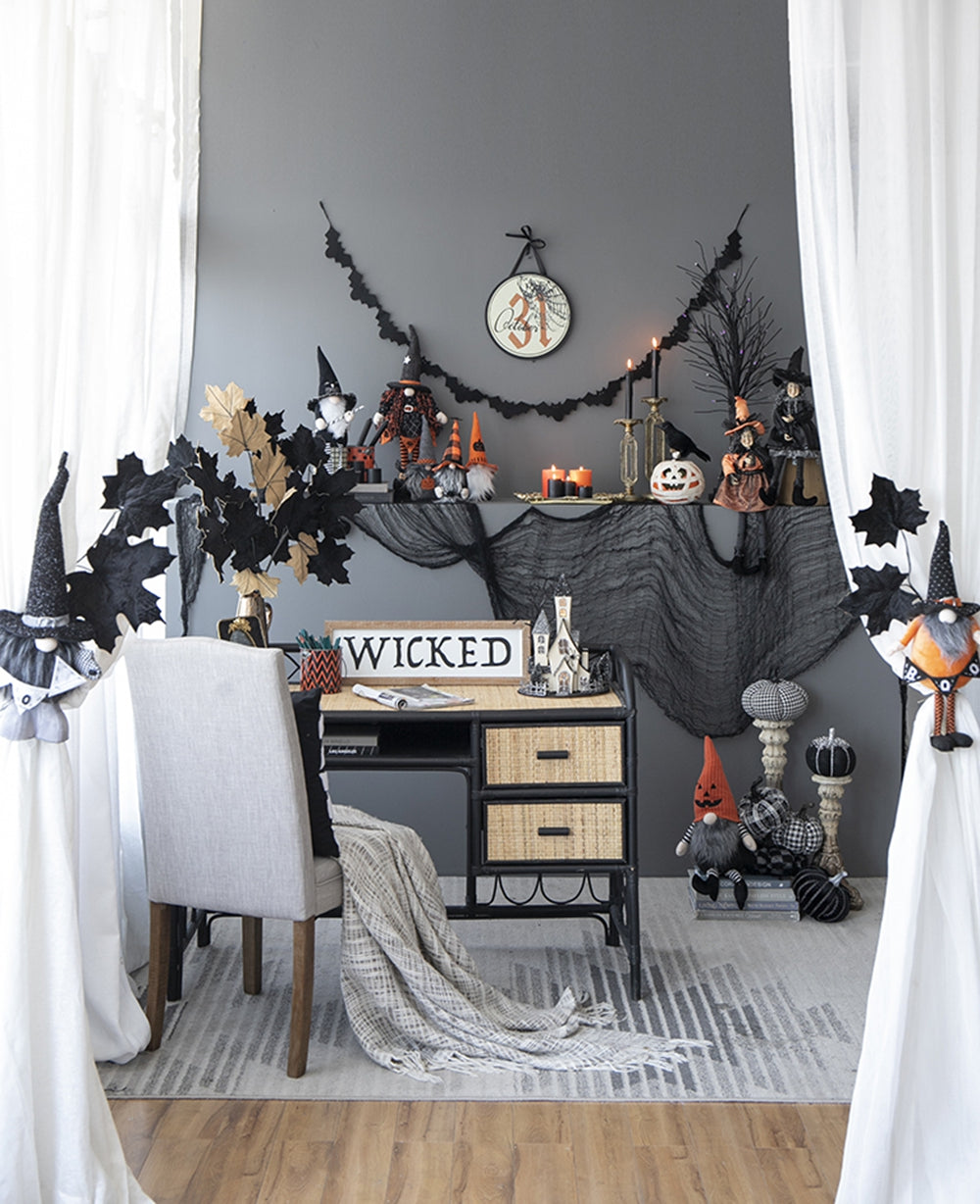 Halloween gnome with witch hat and orange accents hanging on curtain