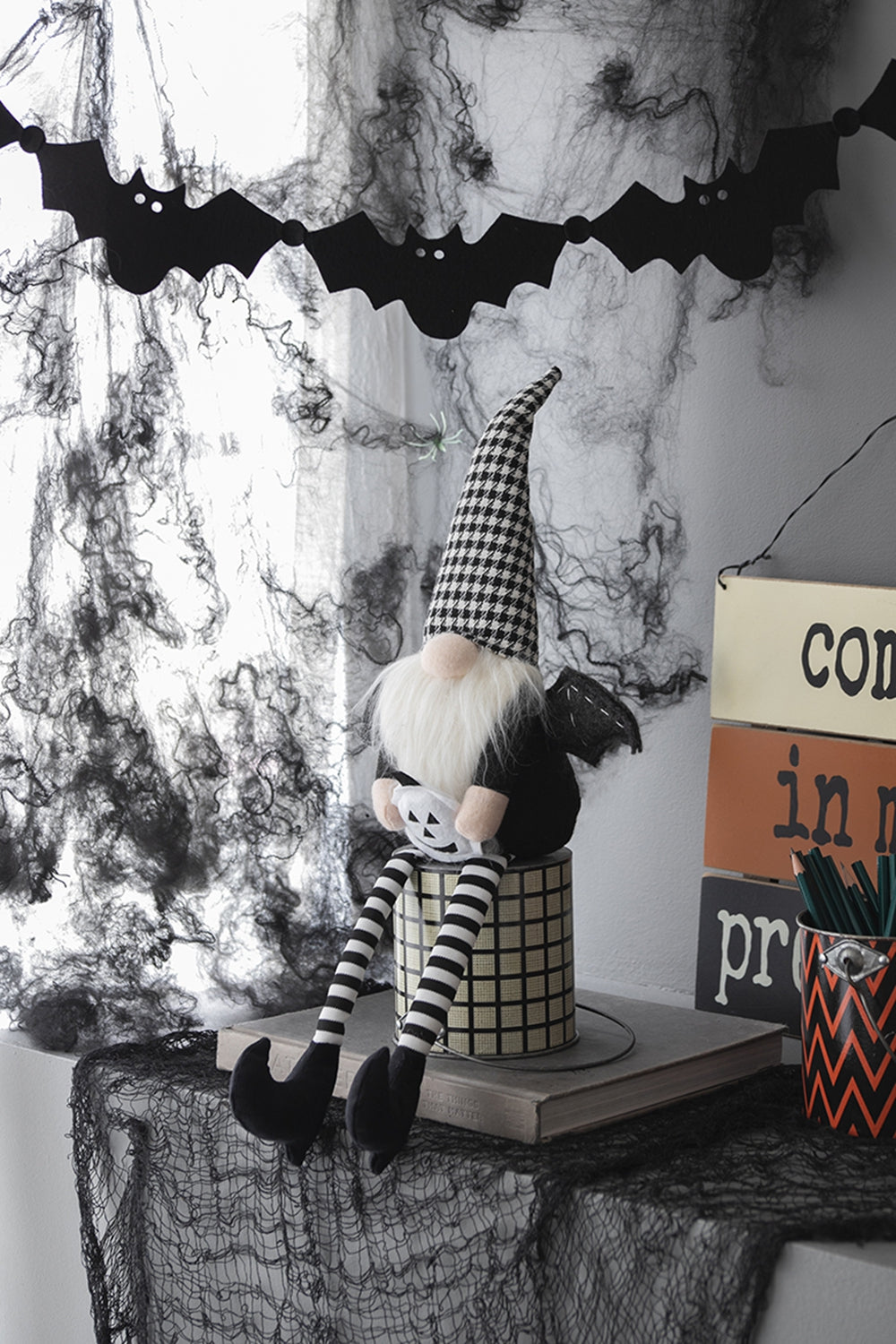Halloween gnome with black and white checkered hat white beard and striped legs