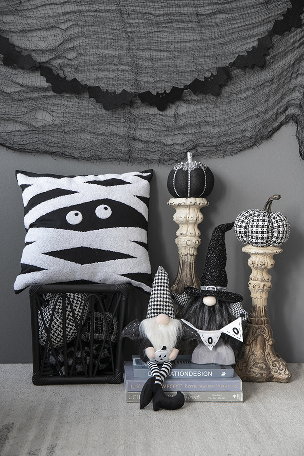 Mummy throw pillow with black and white stripes and googly eyes