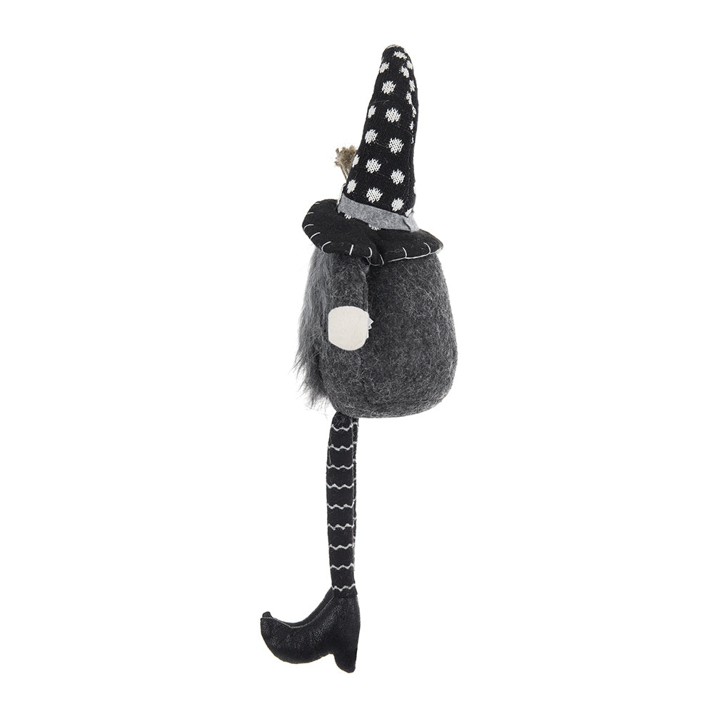 Dark grey plush gnome with black polka dot hat and striped leg