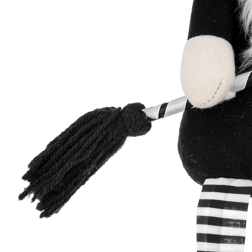 Black tassel tail on a plush gnome with striped legs