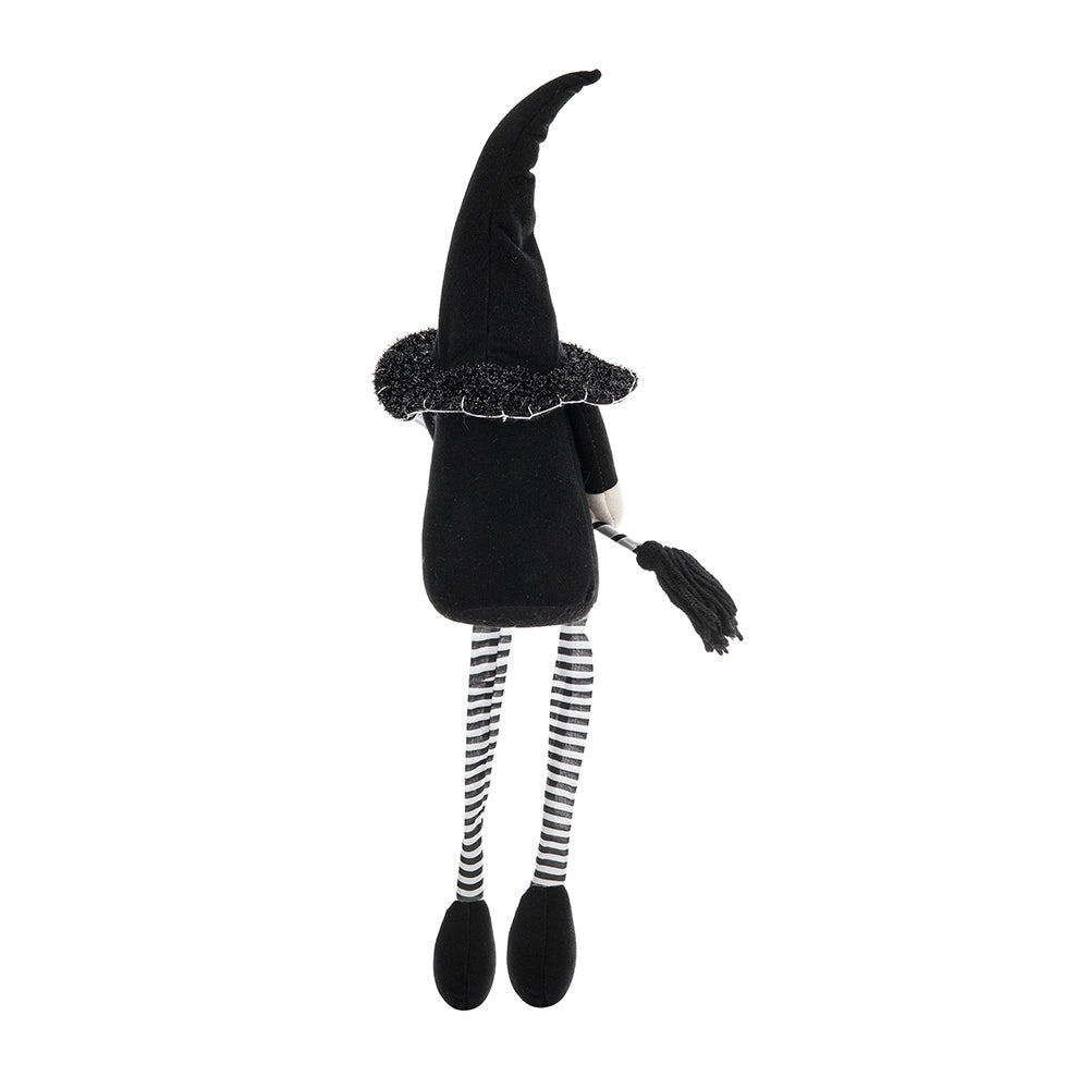 Black plush witch doll with striped legs and a broomstick