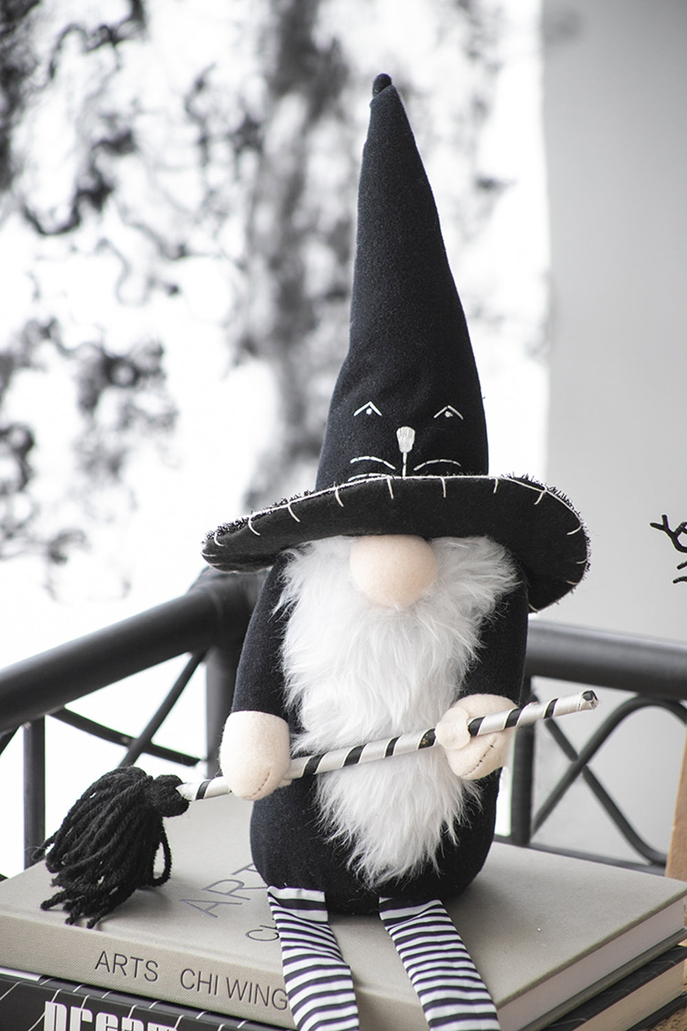 Halloween gnome with black witch hat holding broomstick festive decor