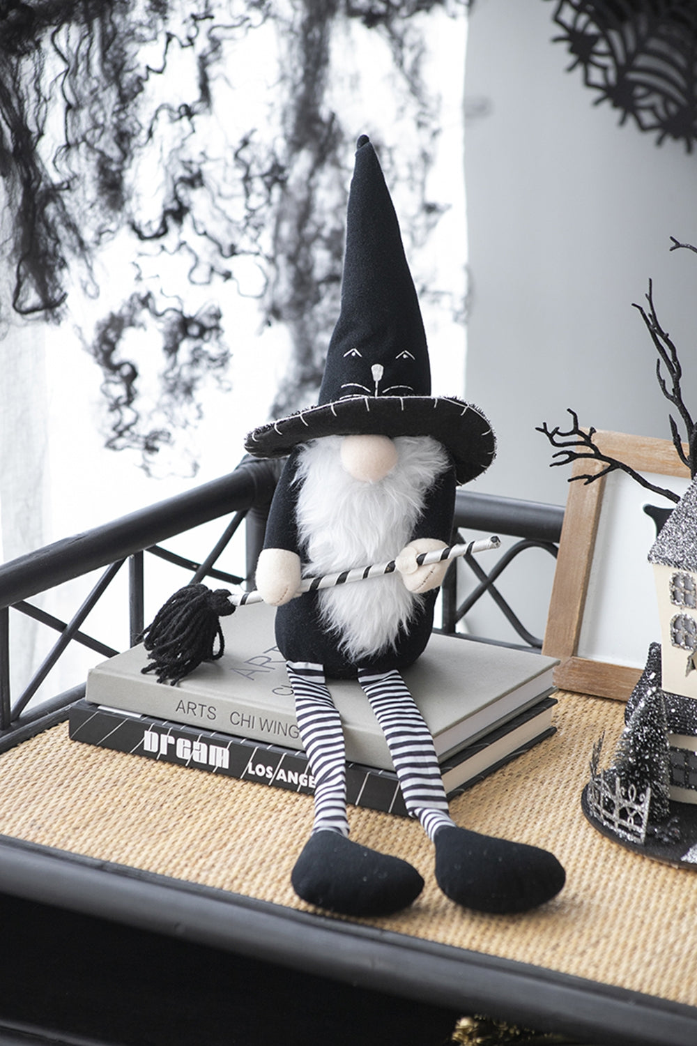 Black Halloween gnome with a witch hat white beard and striped legs