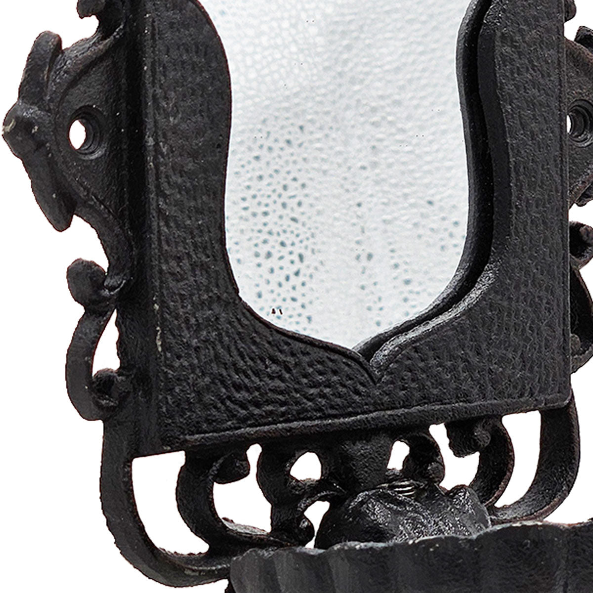 Close up of black ornate cast iron lantern with frosted glass panel