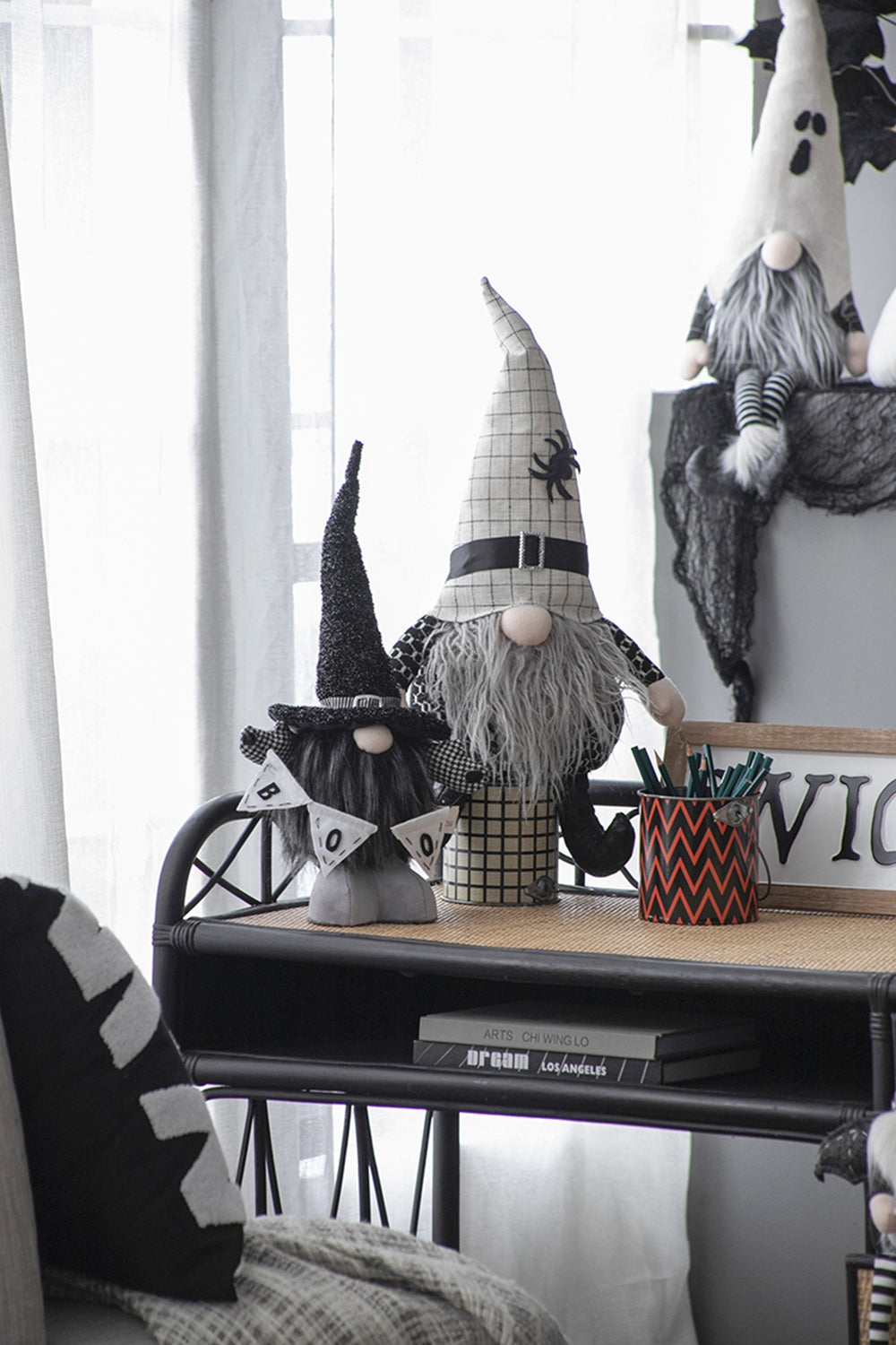 Plush Halloween gnome with a checkered hat and spider accent