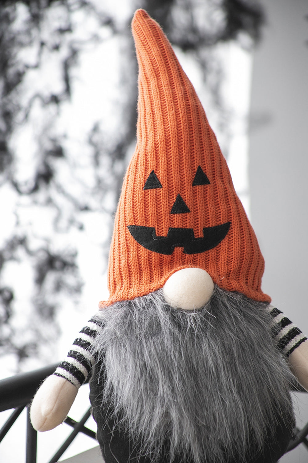 Plush Halloween gnome with an orange pumpkin hat and grey beard