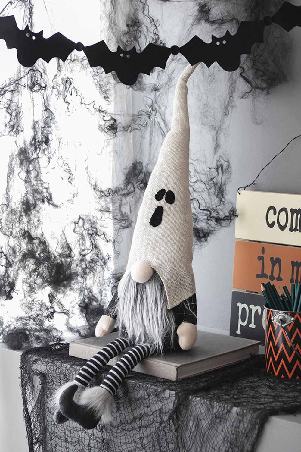 Halloween ghost gnome with long gray beard and striped legs perfect for spooky decor