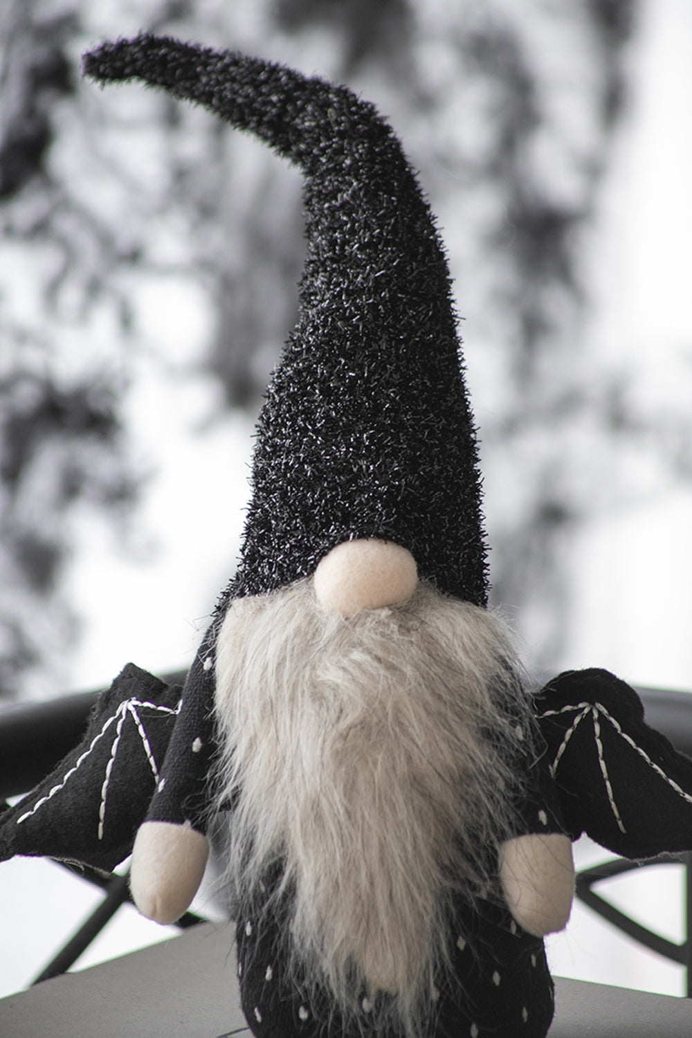 Black textured cone hat gnome with long grey beard white polka dots and bat wings