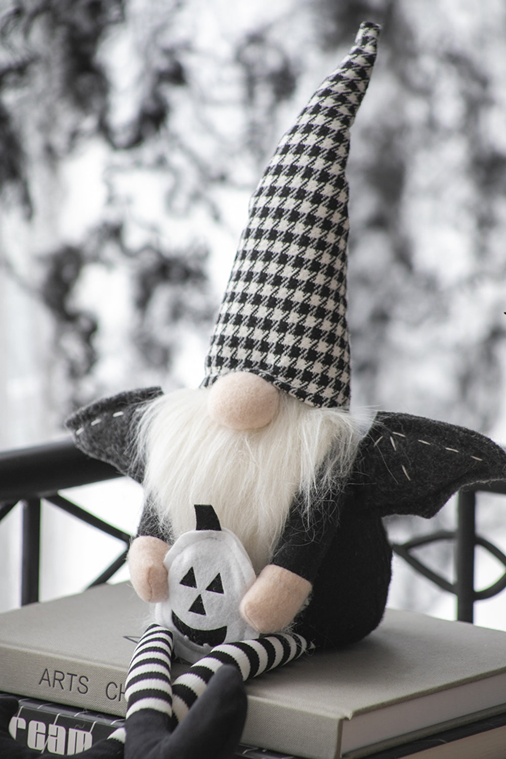 Black and white houndstooth gnome with plush pumpkin and striped legs perfect for Halloween decor