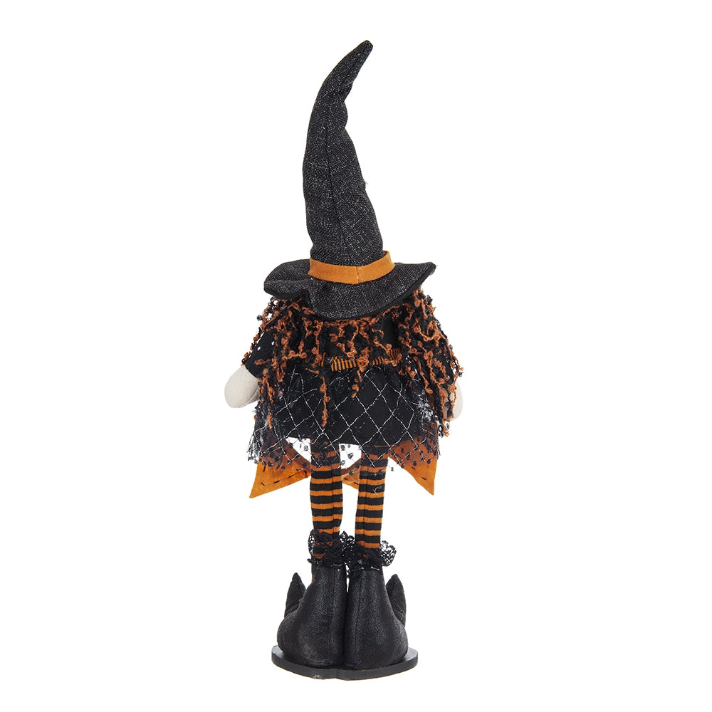 Black plush Halloween witch figure with orange and black striped legs and pointy hat