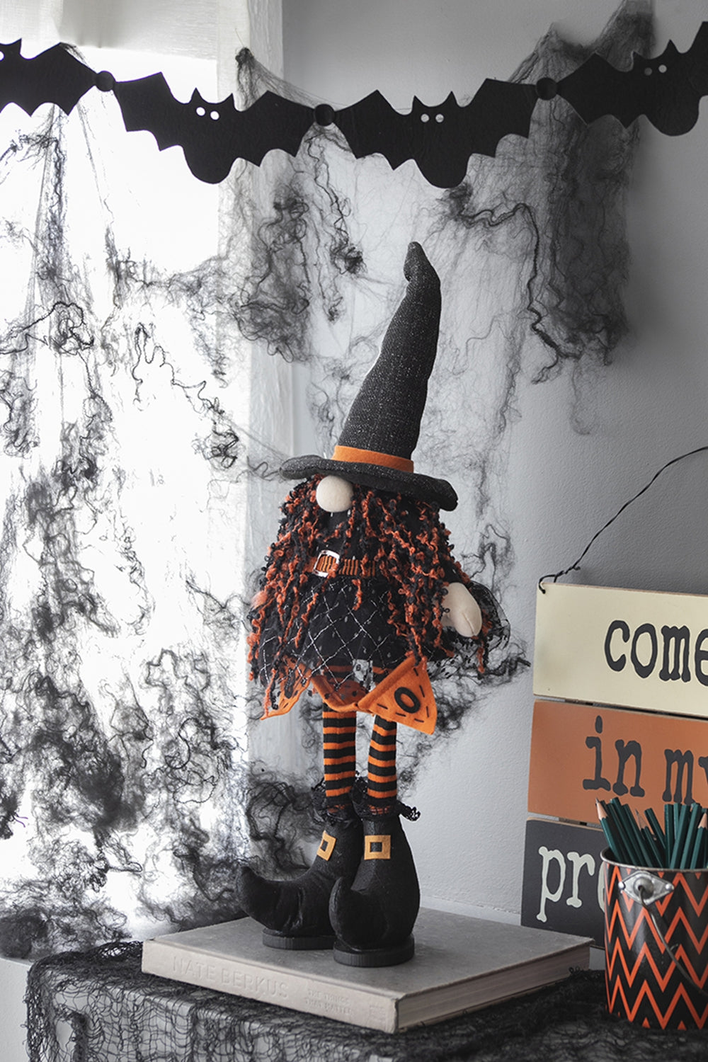 Plush Halloween gnome with orange fuzzy hair and black glitter hat