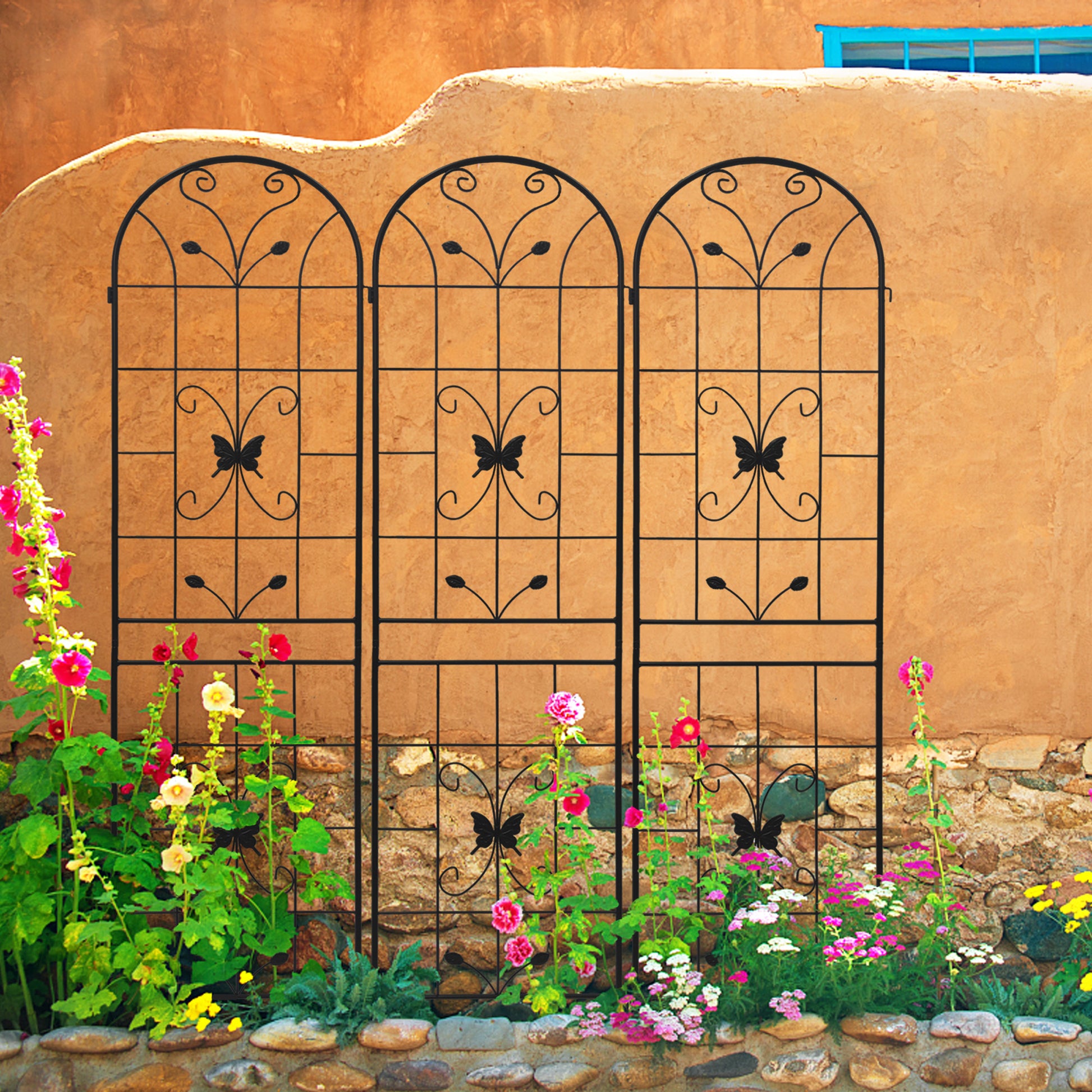 Black metal garden trellis with arched top and decorative butterfly motif