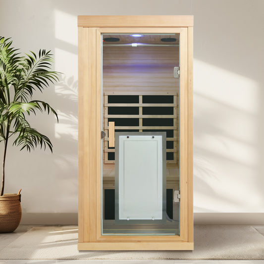 Modern cedar infrared sauna cabin with glass door featuring internal wood paneling and ambient lighting