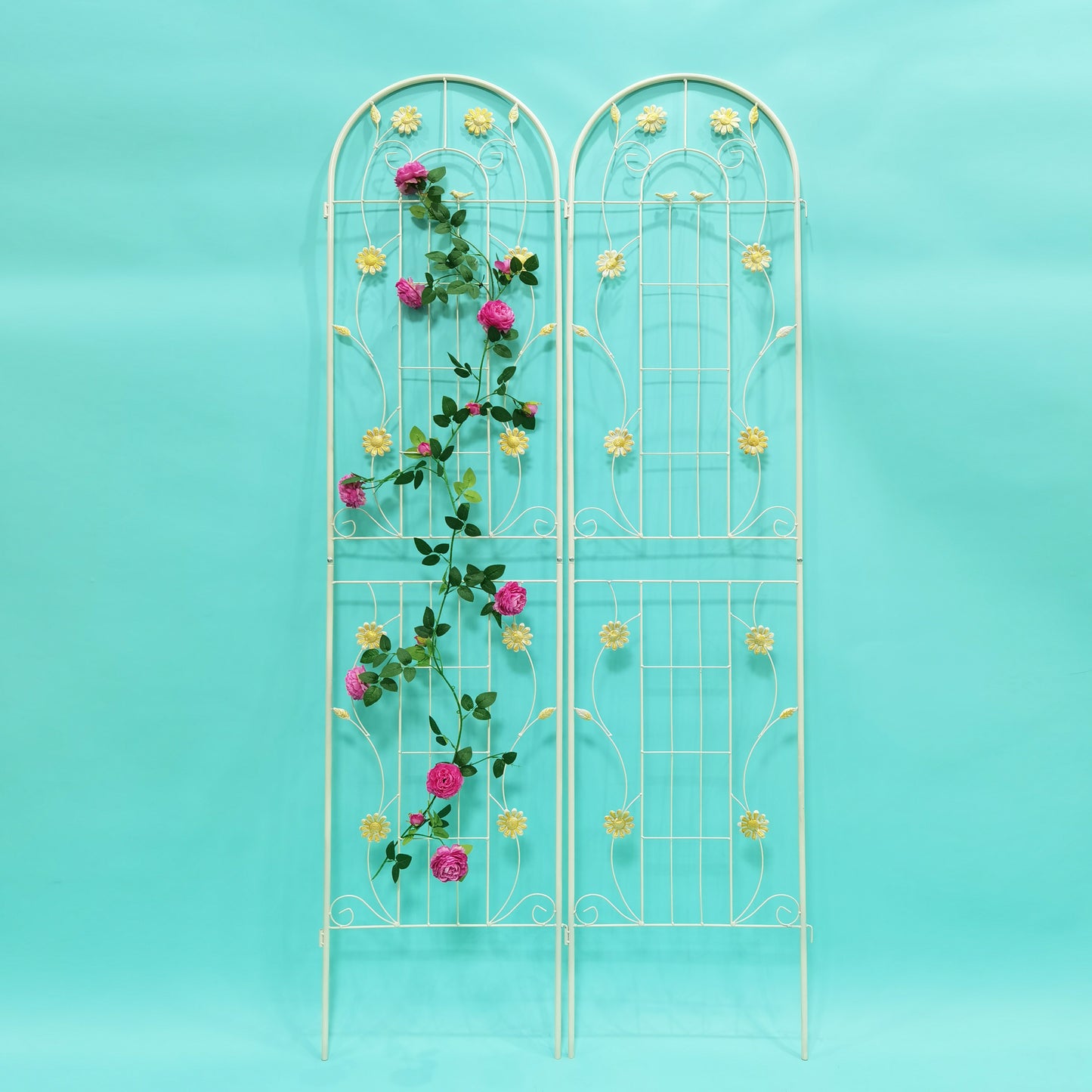 White metal garden trellis with pink roses and yellow floral accents