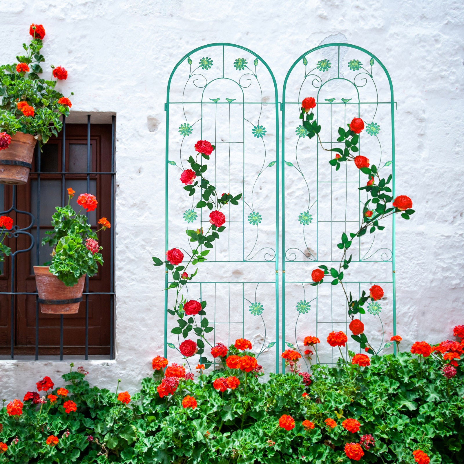 Turquoise metal garden trellis with climbing red roses and green foliage