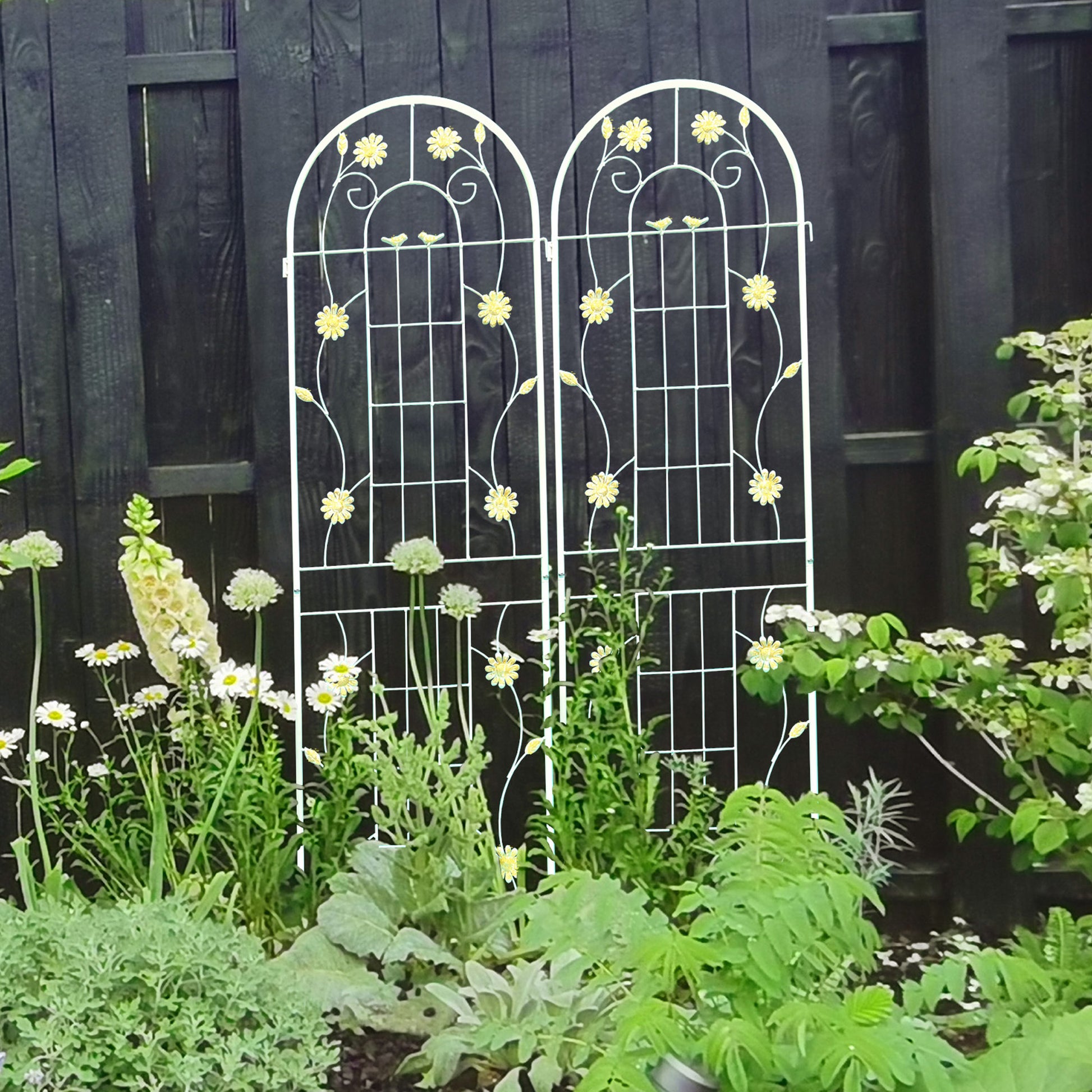 White metal garden trellis with floral accents for climbing plants