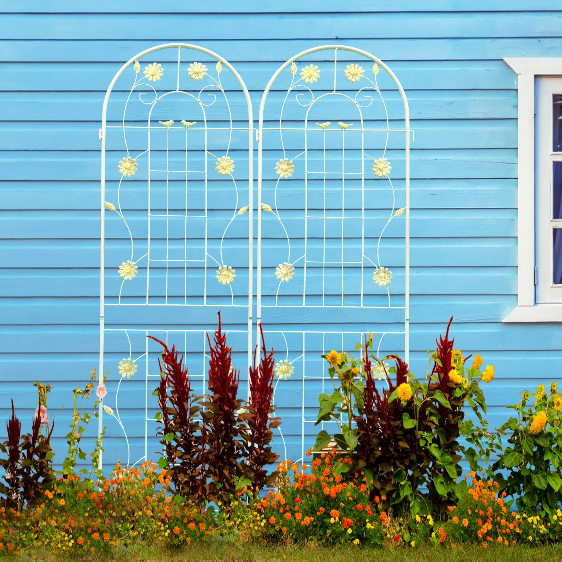 White metal garden trellis with floral and bird accents ideal for climbing plants