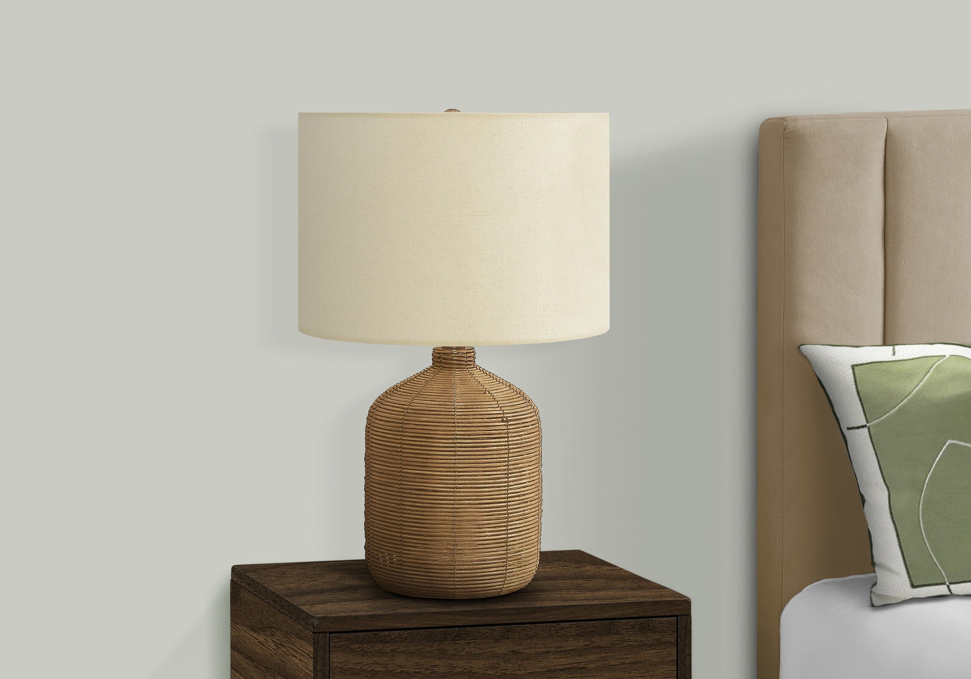 Woven wicker table lamp with cream drum shade for bedside illumination
