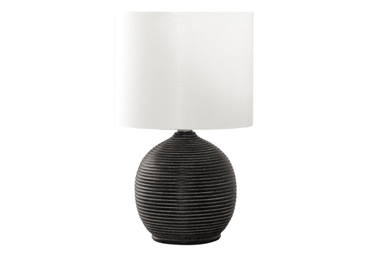 Dark textured ceramic table lamp with a white linen drum shade