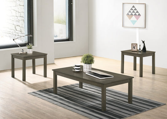 Modern gray coffee table with striped rug and open laptop for workspace
