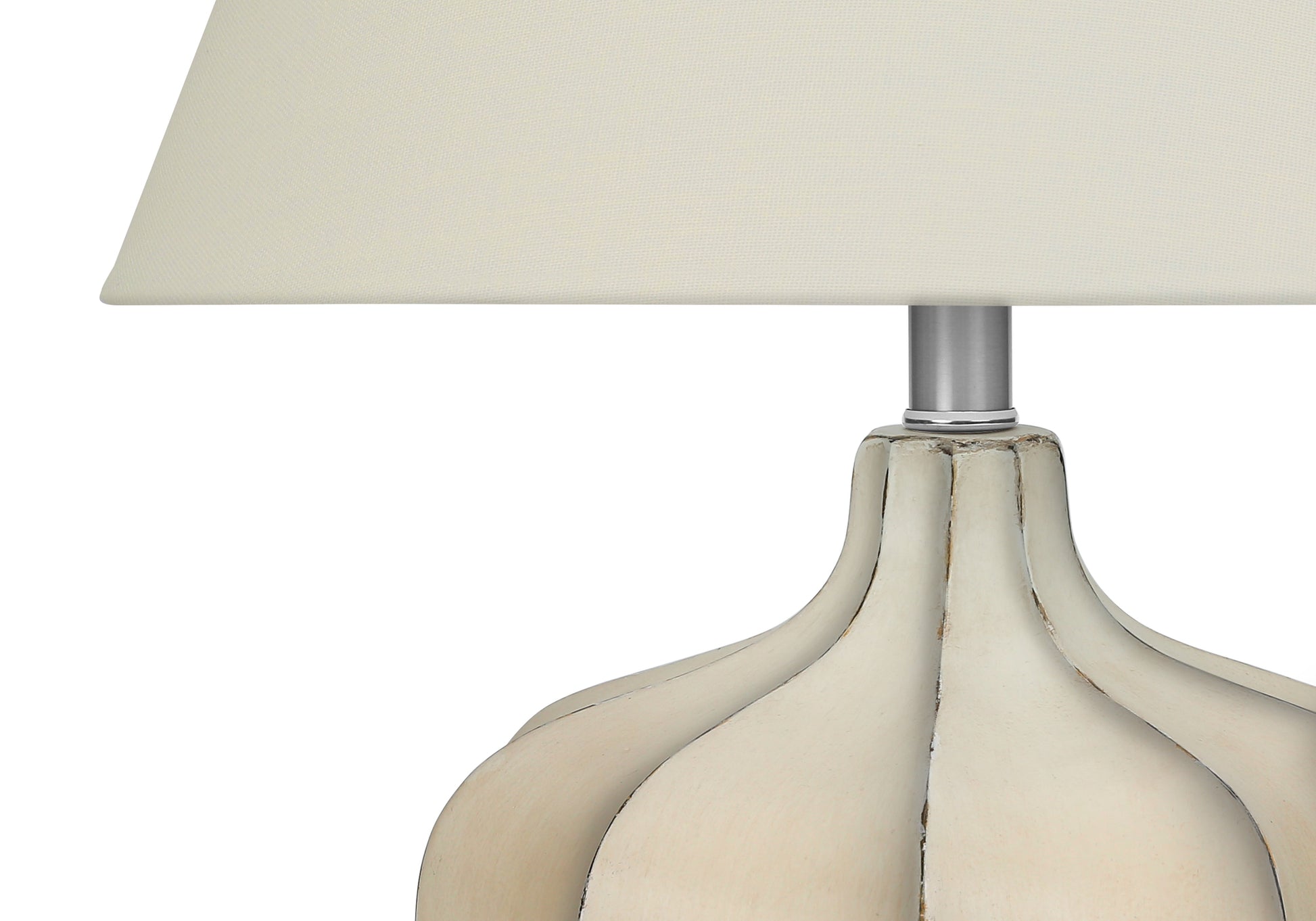 Cream fabric drum lampshade on a distressed white carved base table lamp