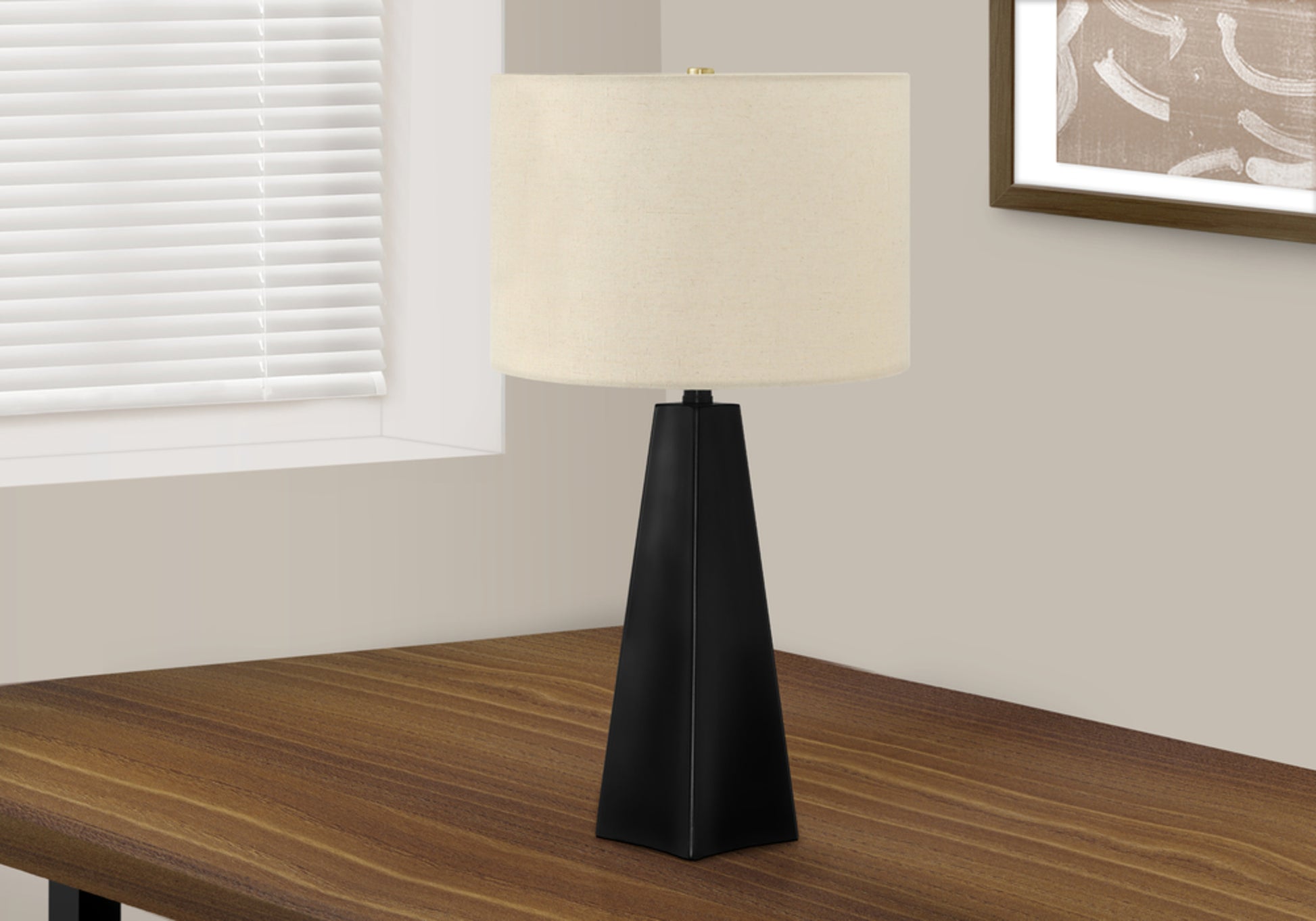 Modern black geometric table lamp with cream drum shade on wooden desk