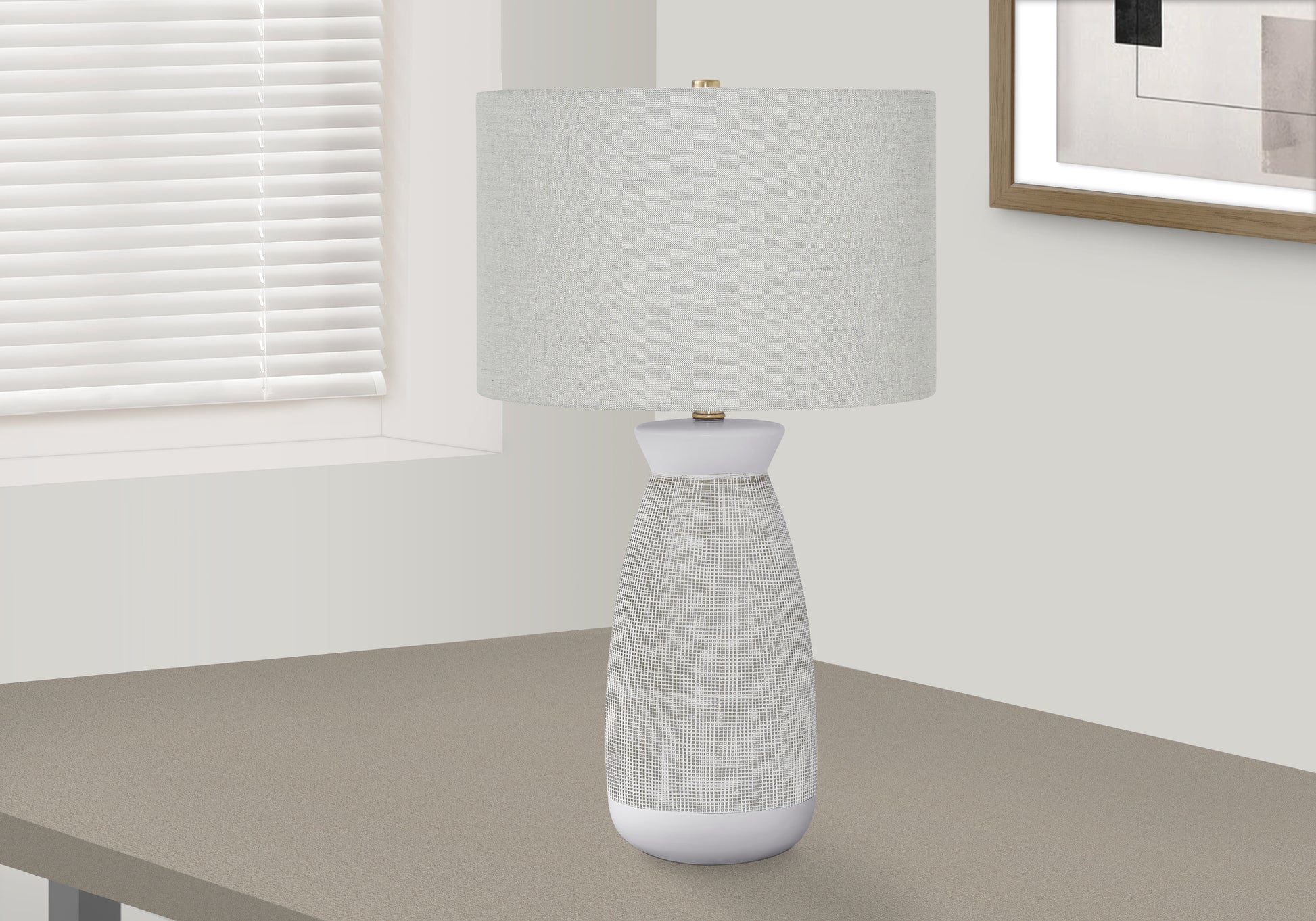 Modern white table lamp with textured base and neutral fabric shade