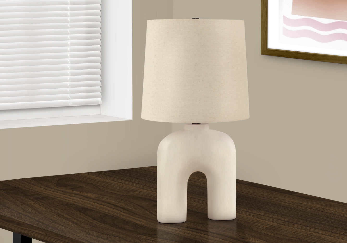 Sculptural cream ceramic table lamp with a natural linen drum shade