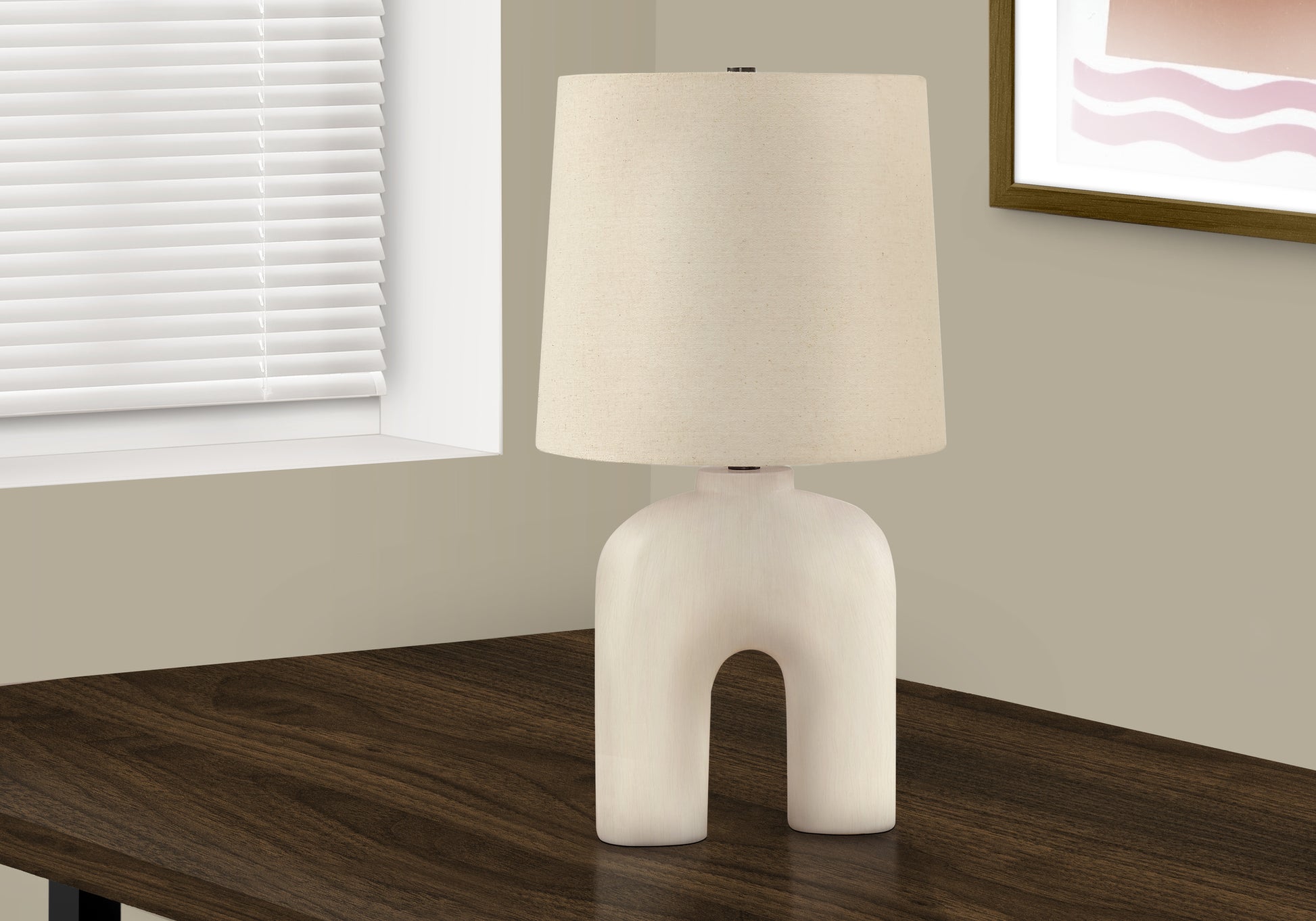 Sculptural cream ceramic table lamp with a natural linen drum shade