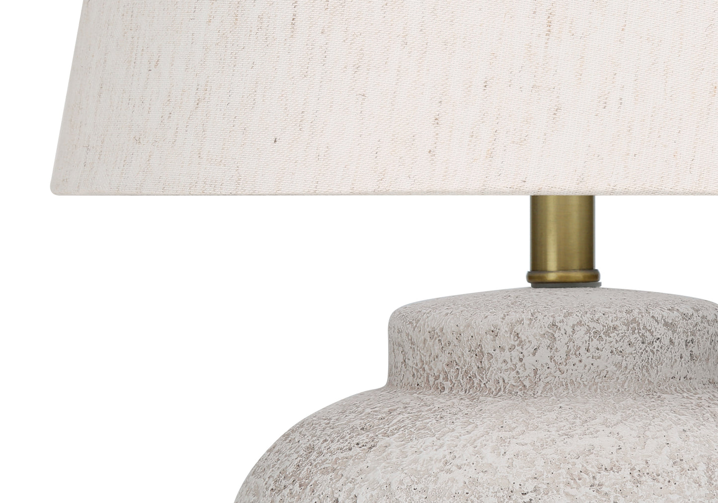 Textured ceramic table lamp base with linen shade and brass stem detail