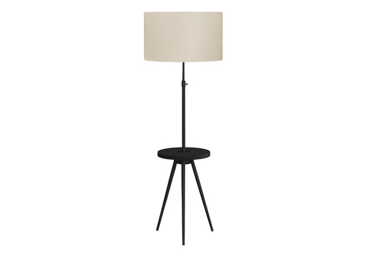 Tall black floor lamp with a round beige shade and integrated side table