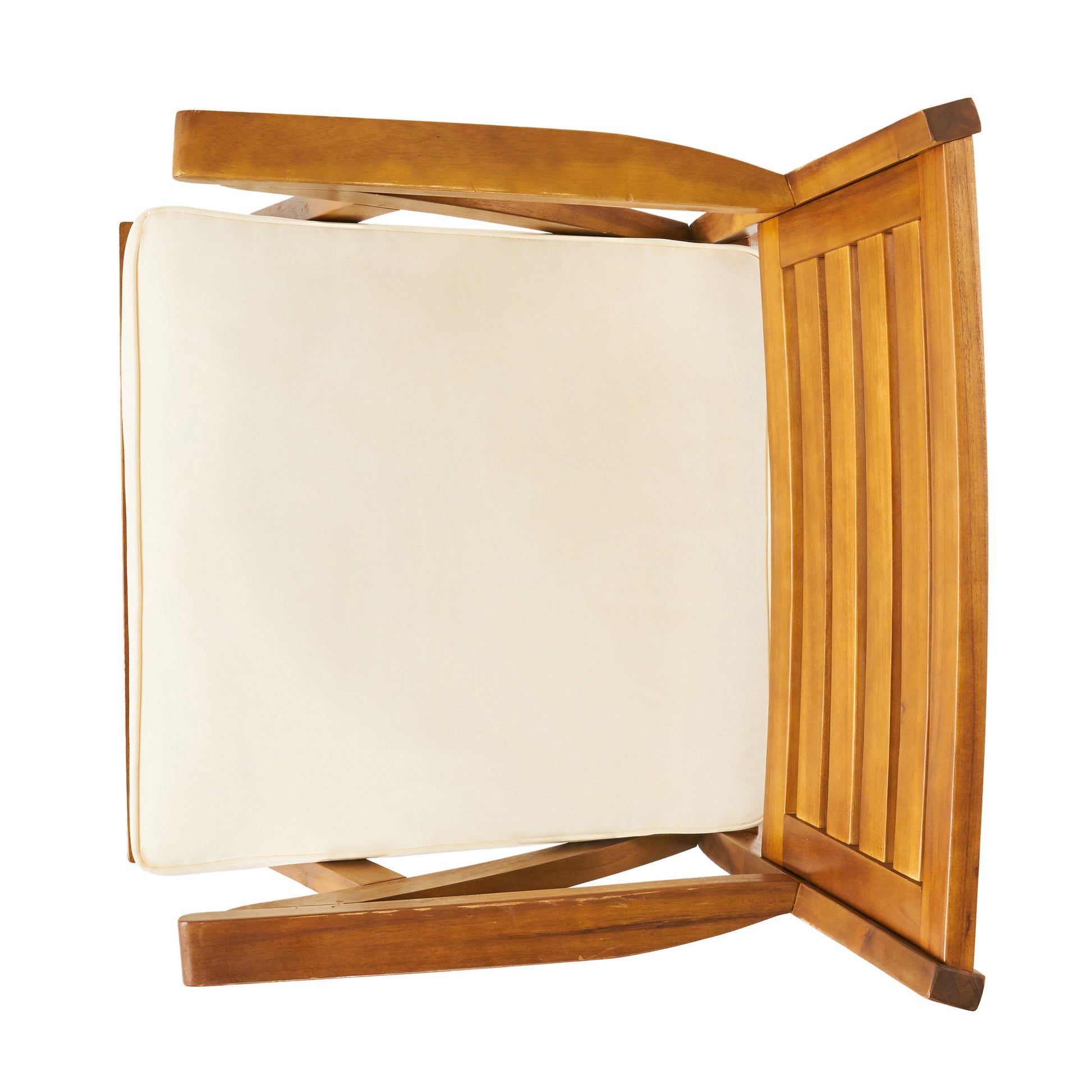 Top view of a natural wood patio chair with a cream cushion