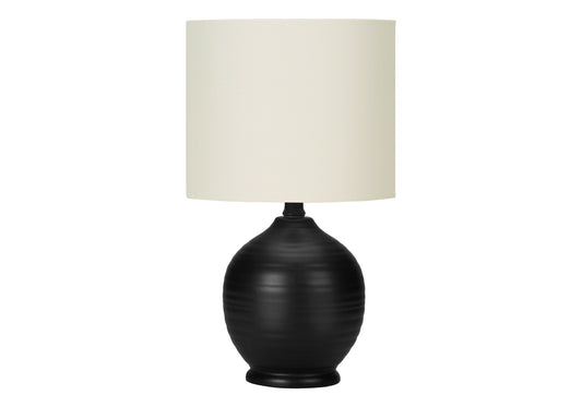 Black ceramic table lamp with textured base and cream linen shade