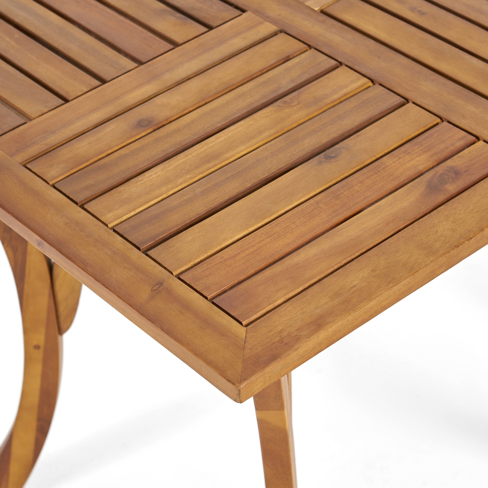 Closeup of a natural wood picnic table with slatted surface and angled legs