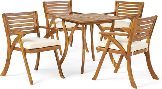 Wooden patio dining set with four chairs and a square table featuring slatted backs and beige cushions