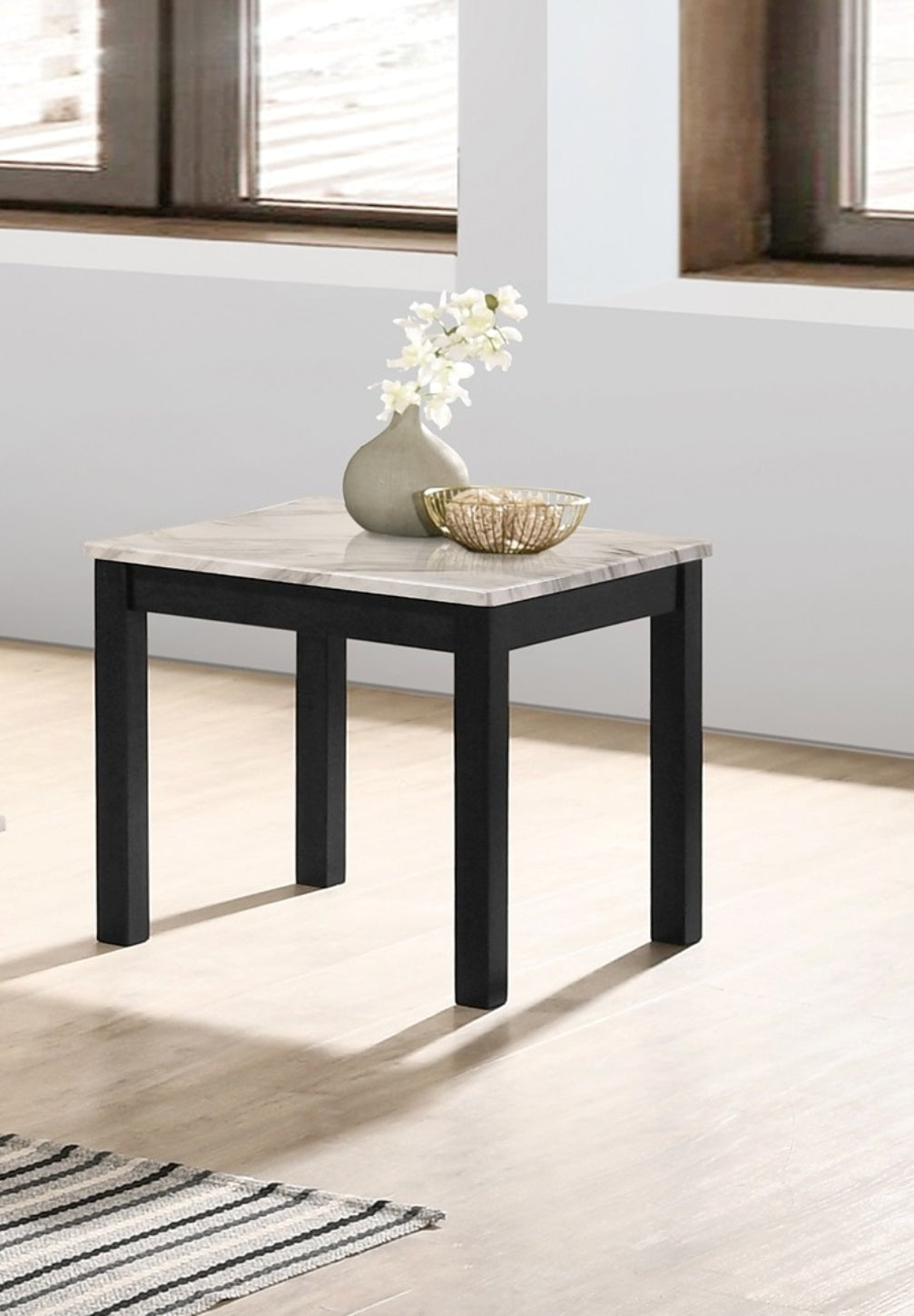 Small end table with marbled top and black wooden legs