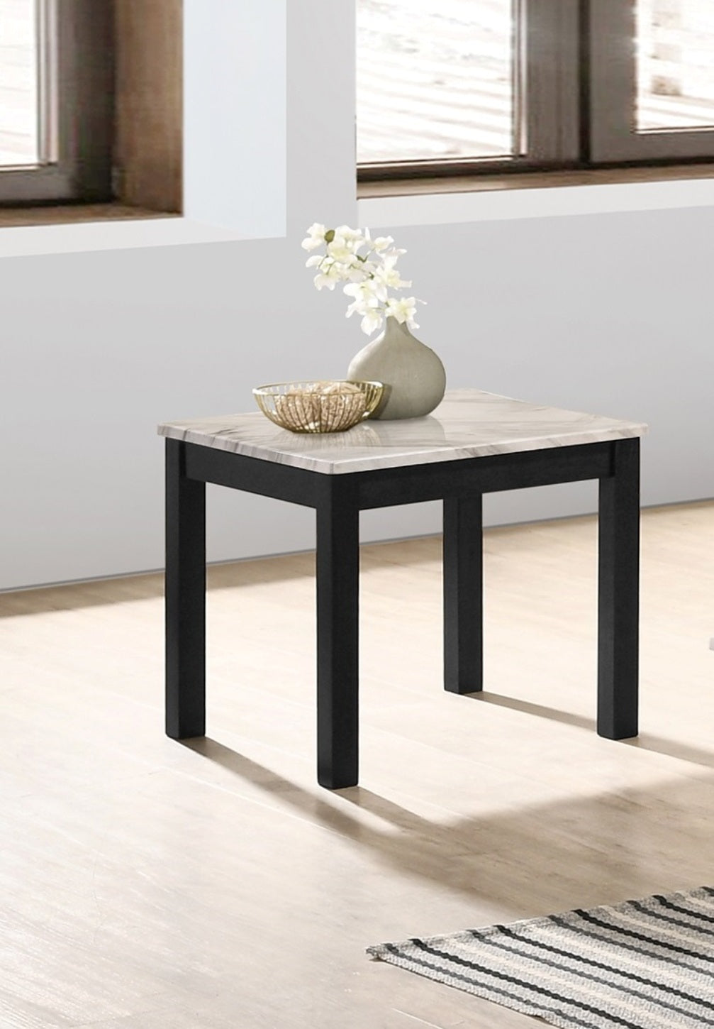 Square faux marble top side table with black wooden legs a decorative item