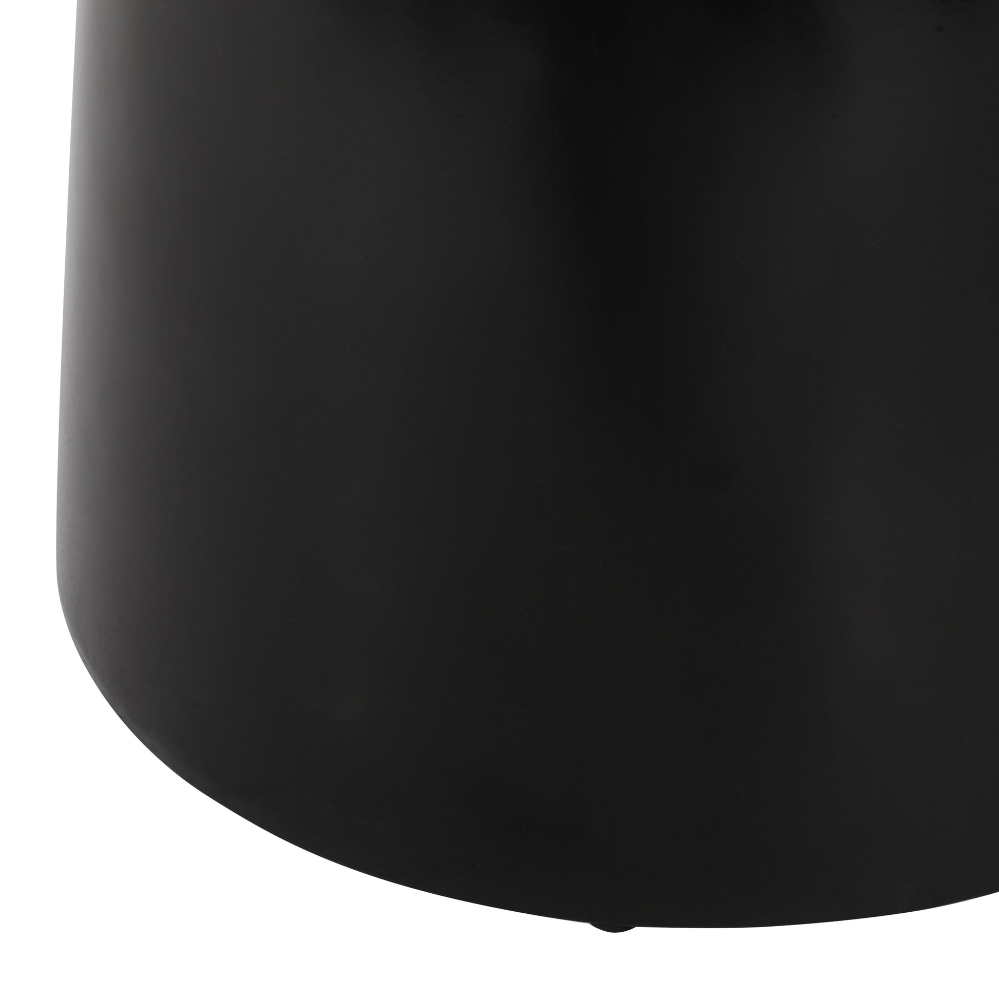 Close up of a black metal cylinder vase showcasing its smooth matte finish and curved base