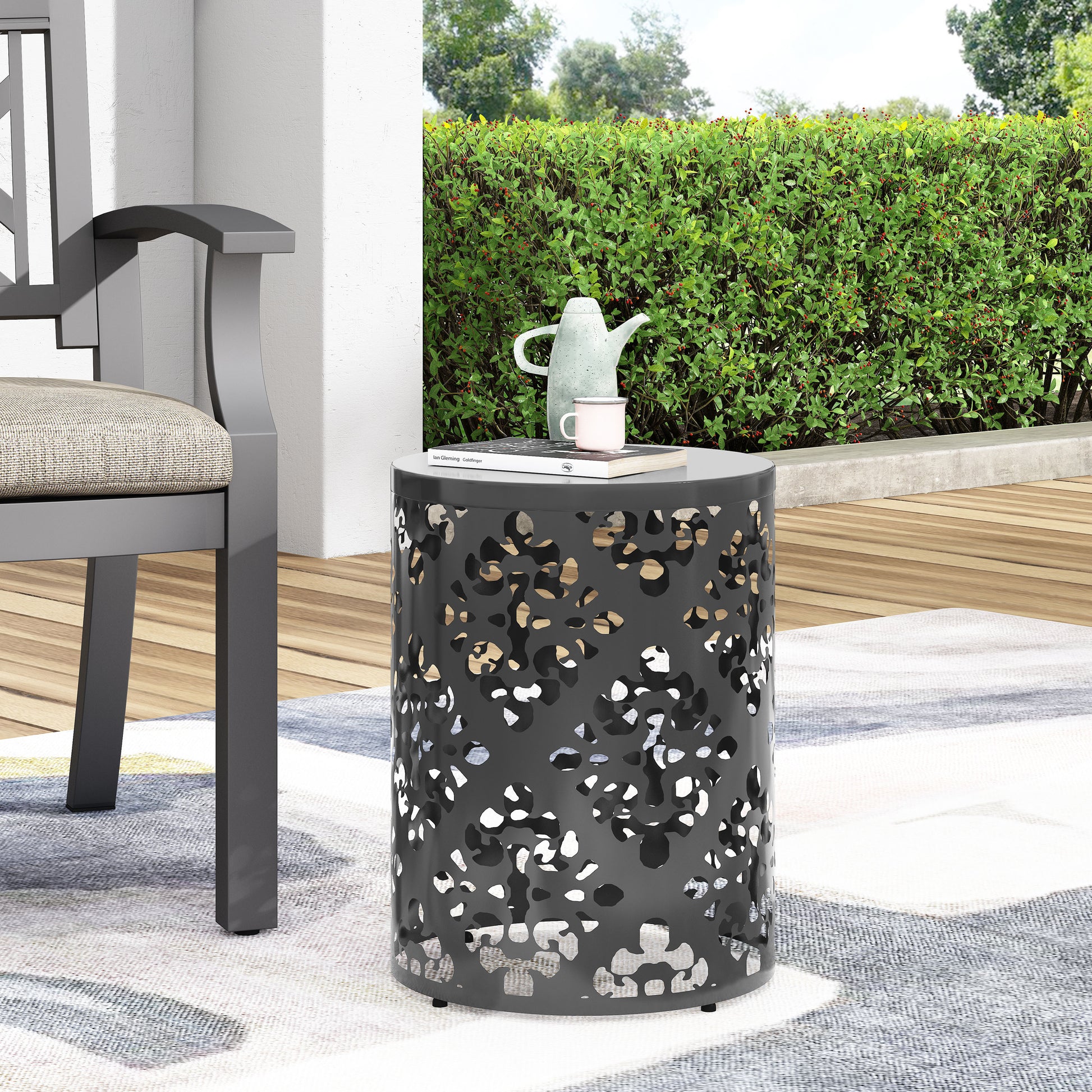 Black metal garden side table with cutout floral design