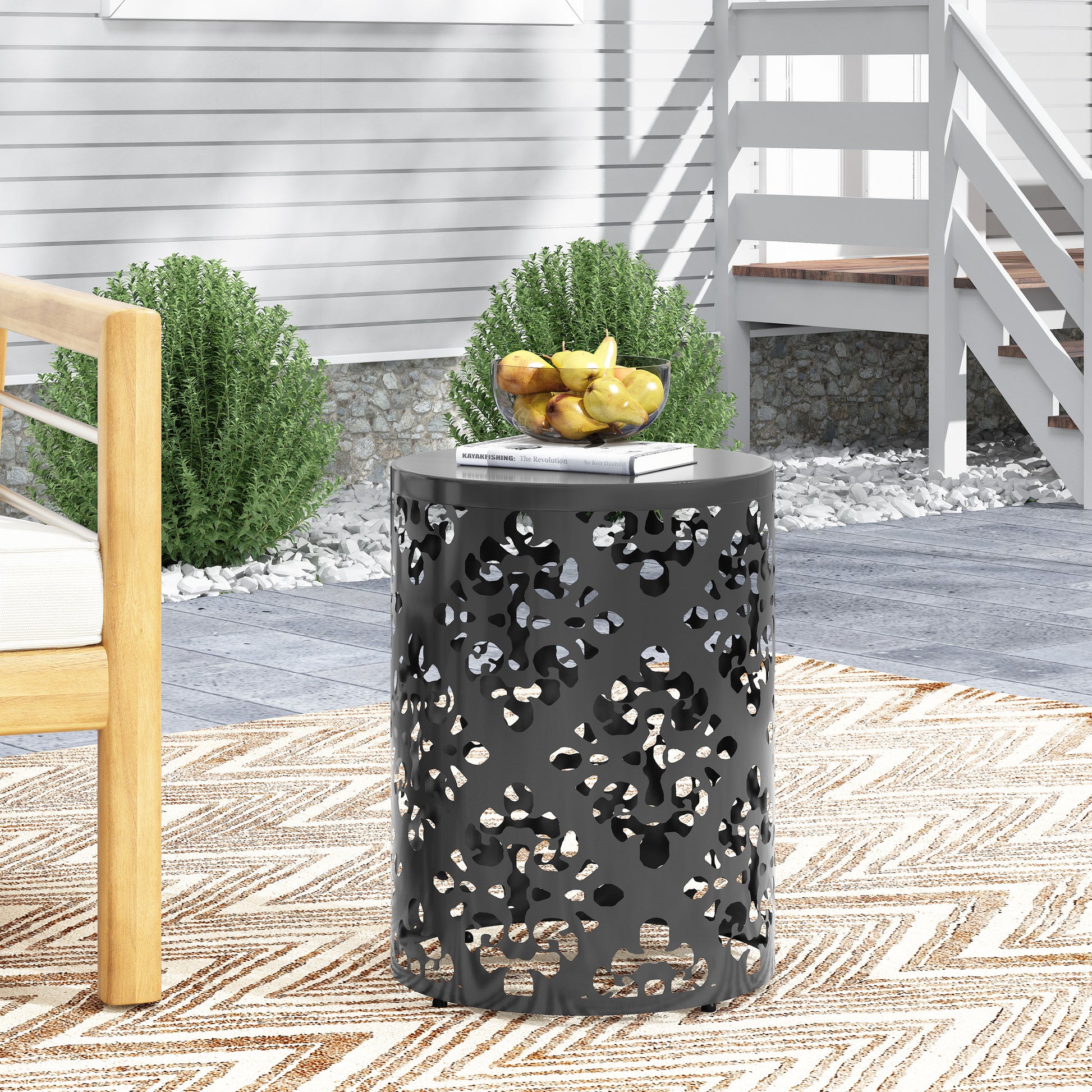 Black metal garden stool with intricate cutout pattern ideal for patio decor
