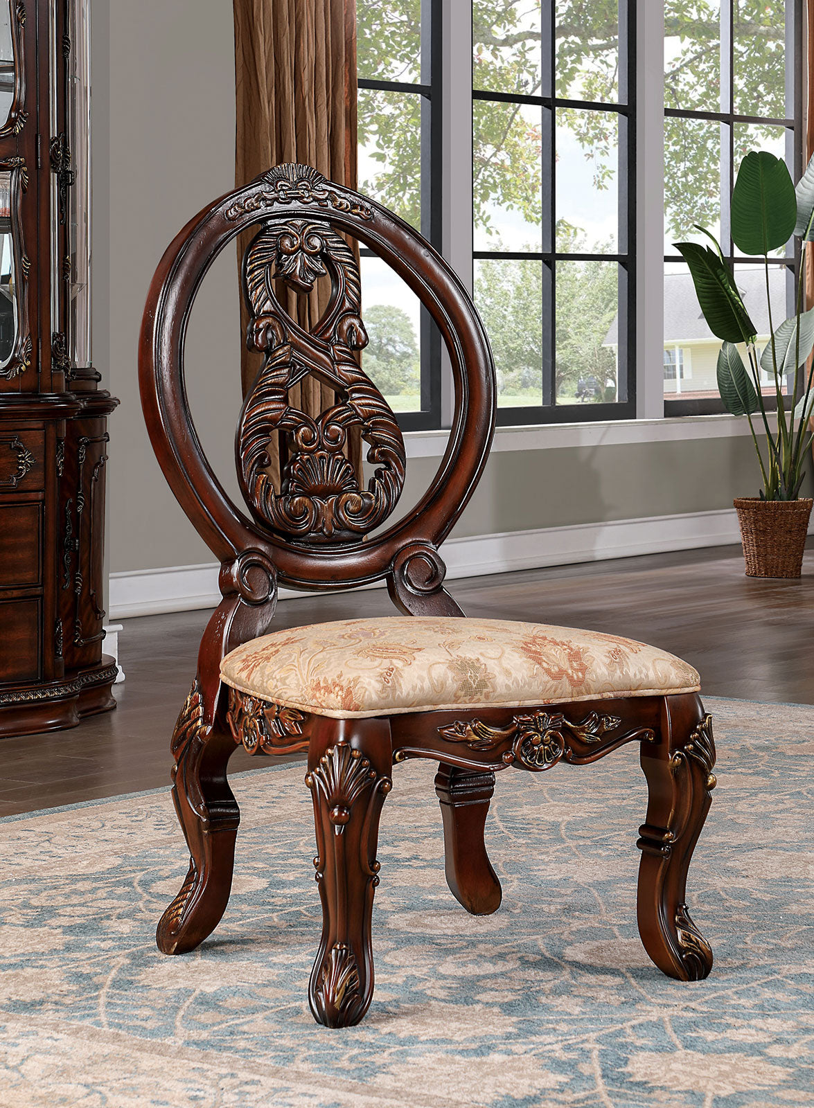 Ornate dark wood vanity stool with scrolled legs and floral patterned seat