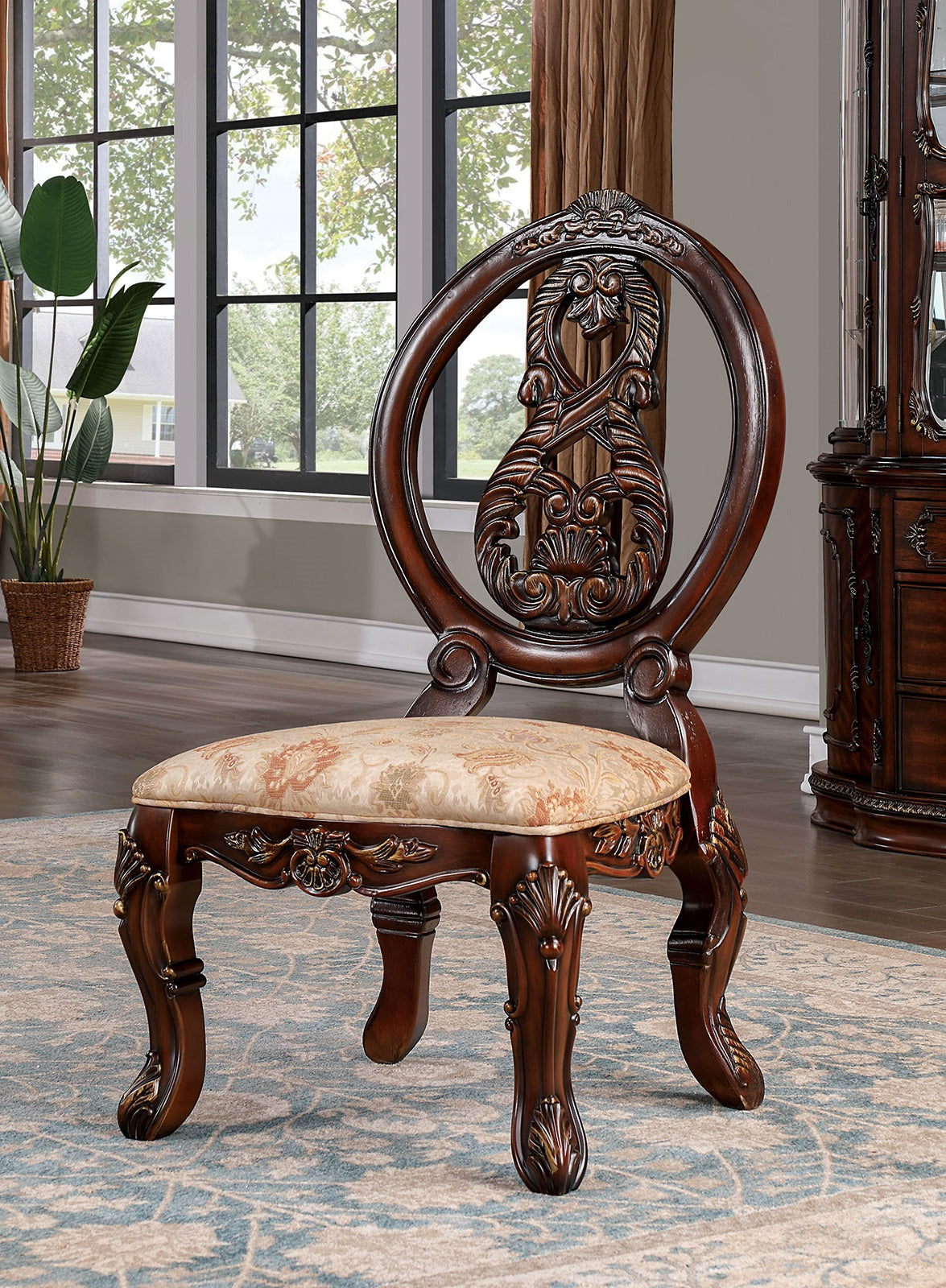 Ornate carved dark wood vanity chair with floral patterned seat for elegant bedrooms