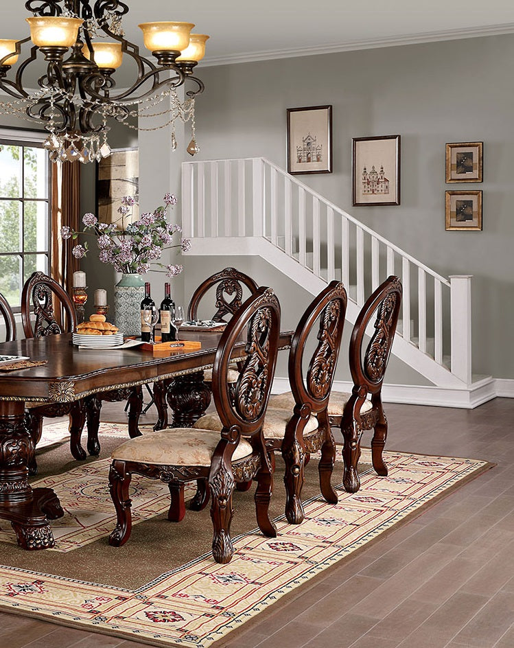 Ornate carved mahogany dining chairs with upholstered seats around a dark wood table